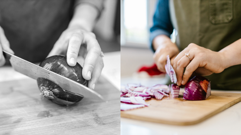 Person using the claw grip technique while slicing red onion on a wooden chopping board with a kitchen knife.
